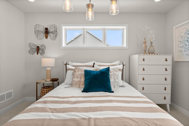 bedroom featuring baseboards, visible vents, and carpet