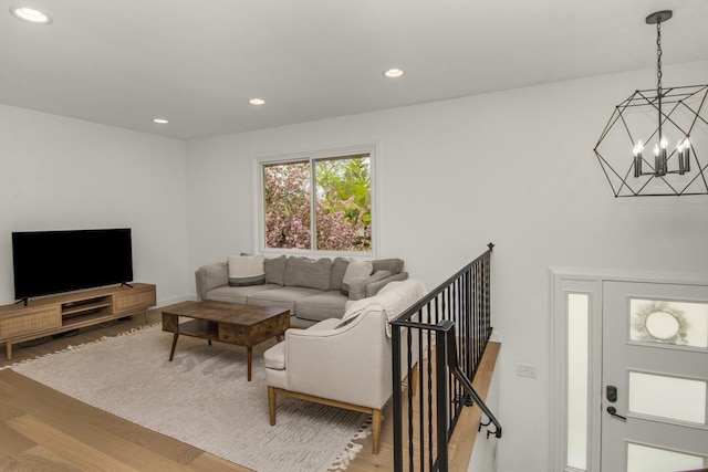 living room with a chandelier, wood finished floors, and recessed lighting