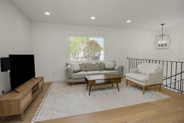 living room featuring a chandelier, light wood-type flooring, recessed lighting, and baseboards