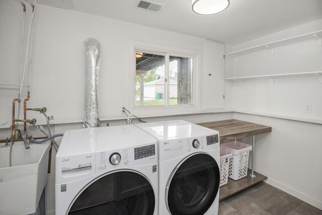 washroom with washer and clothes dryer and baseboards