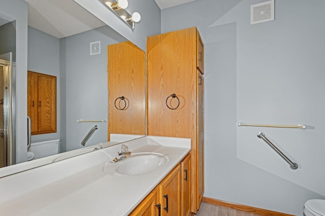 7931 Pinnacle Ave NE, Otsego, MN 55330 - bathroom featuring vanity, a shower with shower door, and wood finished floors