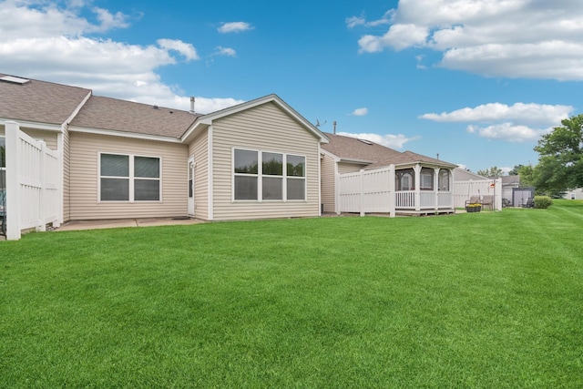 7931 Pinnacle Ave NE, Otsego, MN 55330 - rear view of house featuring a shingled roof, a yard, and a patio