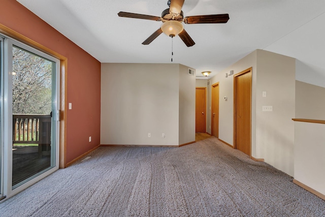 spare room with ceiling fan, visible vents, baseboards, and carpet