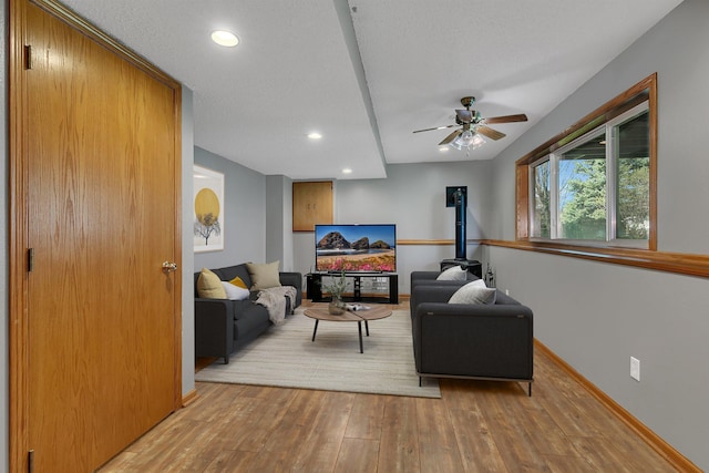 living area featuring baseboards, ceiling fan, recessed lighting, and wood finished floors