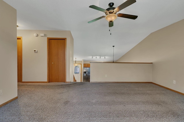 unfurnished room with a ceiling fan, baseboards, track lighting, and carpet