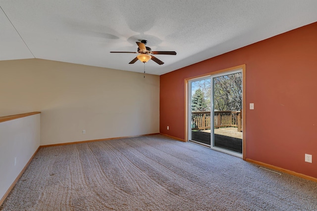 carpeted empty room with baseboards, ceiling fan, a textured ceiling, and visible vents