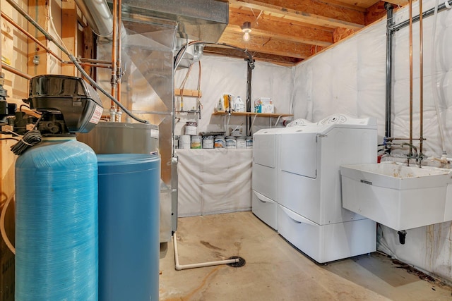 washroom with laundry area, a sink, and washer and dryer