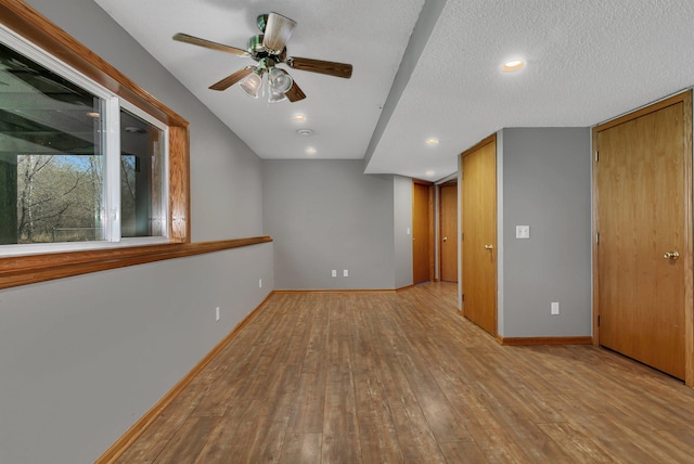 empty room with baseboards, ceiling fan, recessed lighting, and hardwood / wood-style floors