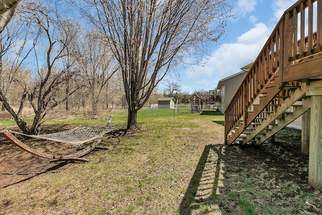 view of yard with a wooden deck and stairs