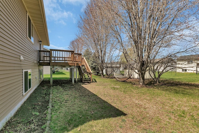 view of yard with a wooden deck and stairs
