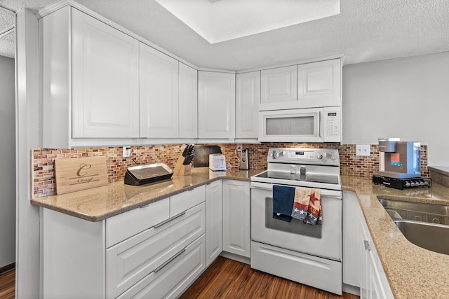 6085 Lincoln Dr Unit 122, Edina, MN 55436 - kitchen featuring decorative backsplash, white cabinetry, dark wood-type flooring, and white appliances
