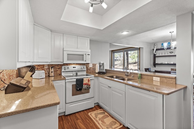 6085 Lincoln Dr Unit 122, Edina, MN 55436 - kitchen with white cabinets, a peninsula, a sink, and white appliances