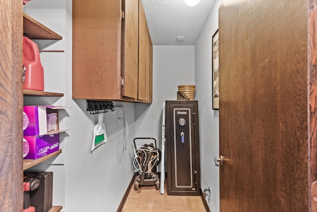 6085 Lincoln Dr Unit 122, Edina, MN 55436 - clothes washing area with wood finished floors, a textured ceiling, and baseboards