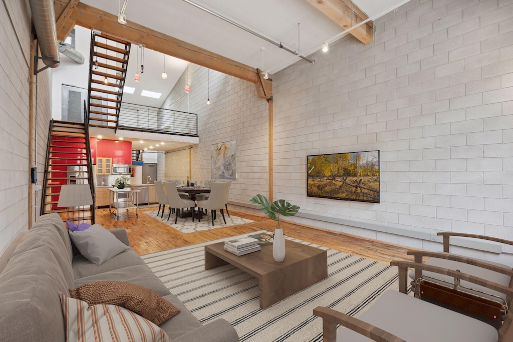 801 Washington Ave N Unit 316, Minneapolis, MN 55401 - living room with a skylight, wood finished floors, a towering ceiling, and beamed ceiling
