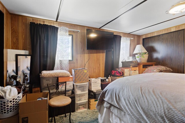 bedroom with wooden walls and multiple windows