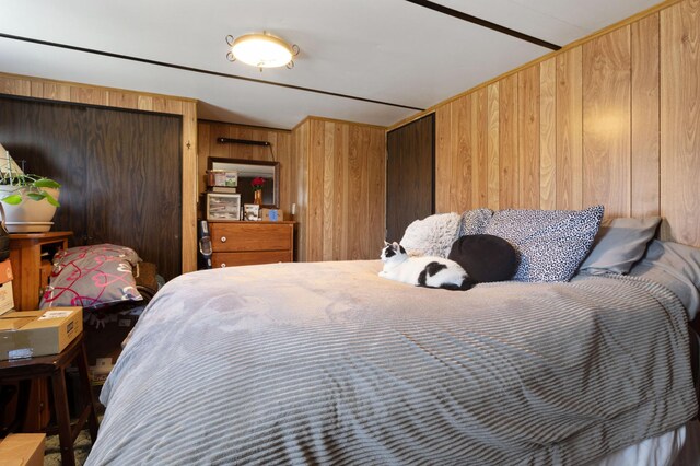 bedroom with wood walls