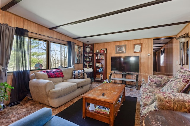 living area with wooden walls and beamed ceiling