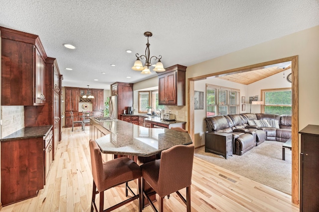 4545 Terraceview Ln N, Plymouth, MN 55446 - dining space featuring a chandelier, light wood finished floors, plenty of natural light, recessed lighting, and a textured ceiling
