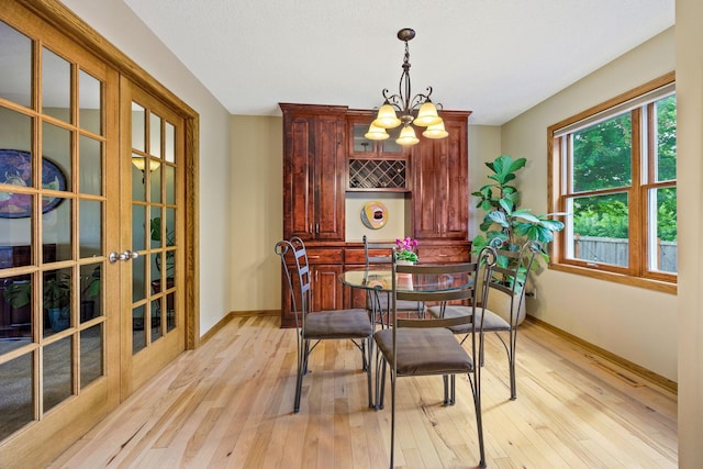 4545 Terraceview Ln N, Plymouth, MN 55446 - dining space with baseboards, a chandelier, light wood finished floors, and french doors