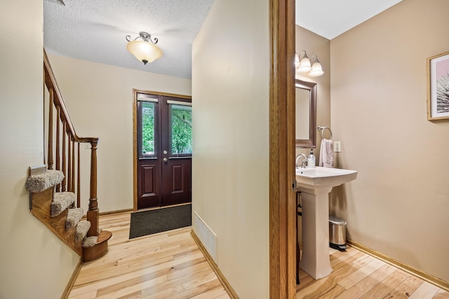 4545 Terraceview Ln N, Plymouth, MN 55446 - foyer featuring light wood-style flooring, stairway, and baseboards