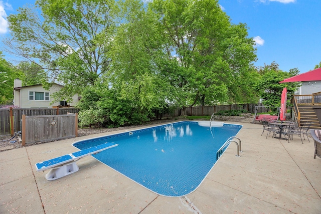 4545 Terraceview Ln N, Plymouth, MN 55446 - view of pool with a fenced backyard, a diving board, a patio area, and view of scattered trees