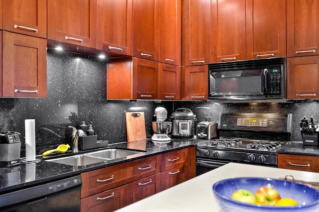 kitchen featuring decorative backsplash, black appliances, and a sink