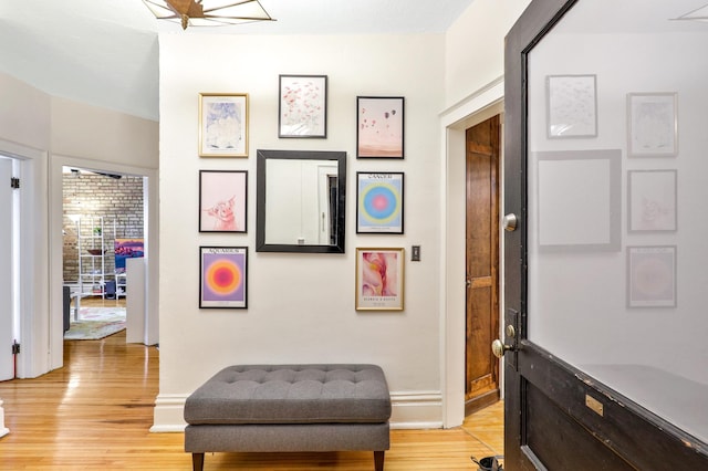 sitting room with light wood-type flooring and baseboards