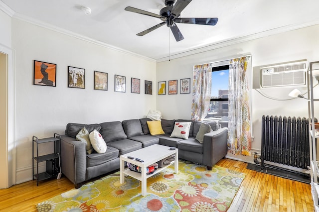 living room with radiator, hardwood / wood-style flooring, crown molding, a wall mounted AC, and ceiling fan