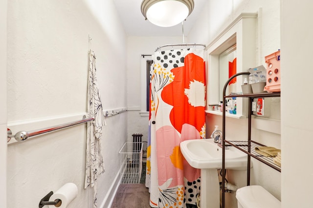 full bath with a shower with curtain and toilet