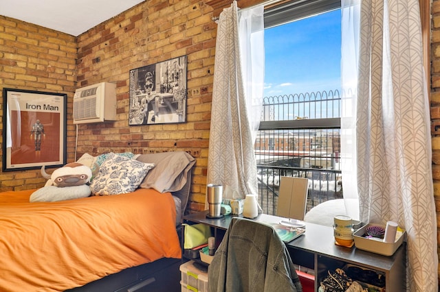 bedroom featuring brick wall and a wall unit AC