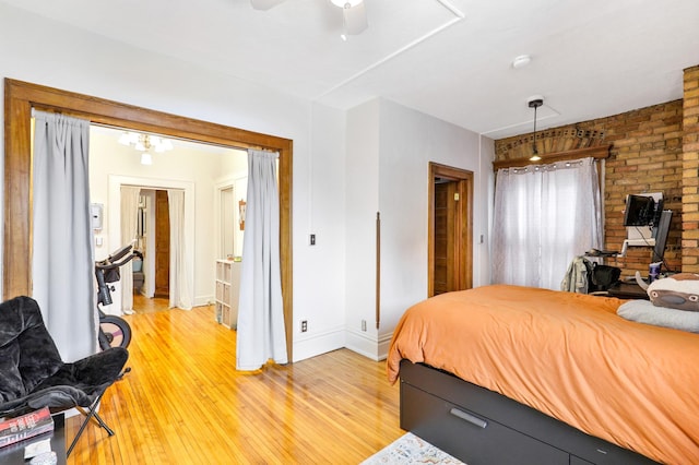 bedroom featuring baseboards, light wood-style floors, and a ceiling fan