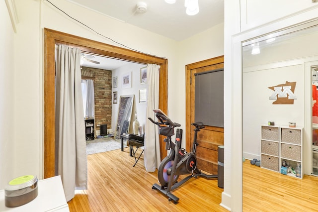 exercise room with light wood-style floors