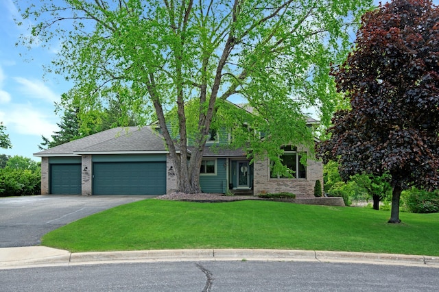 2806 Jasmine Ct, Saint Cloud, MN 56301 - view of front facade with concrete driveway, an attached garage, a front lawn, a shingled roof, and brick siding