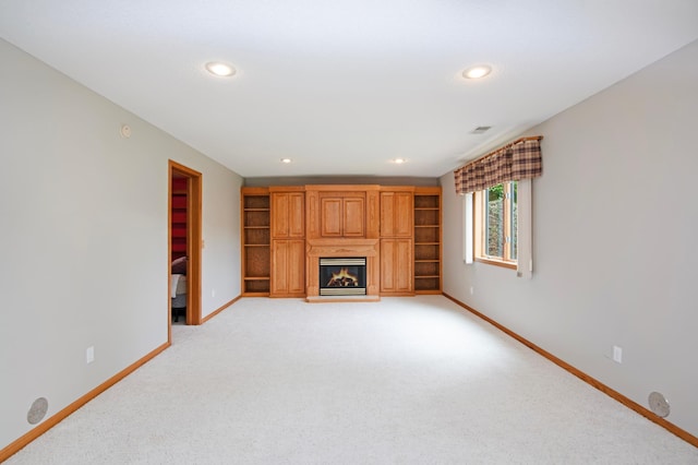 2806 Jasmine Ct, Saint Cloud, MN 56301 - unfurnished living room with light carpet, baseboards, a glass covered fireplace, and recessed lighting