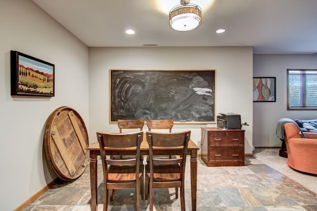 dining area with baseboards, stone finish flooring, and recessed lighting