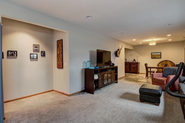 carpeted living area with baseboards and recessed lighting