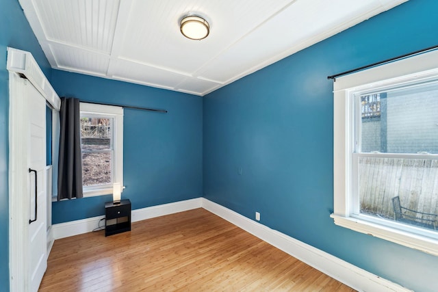 2943 Taylor St NE, Minneapolis, MN 55418 - spare room featuring baseboards, plenty of natural light, and wood finished floors