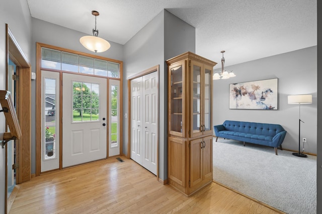 4032 Hollyhock Cir N, Brooklyn Park, MN 55443 - foyer entrance with light wood-style floors and a chandelier
