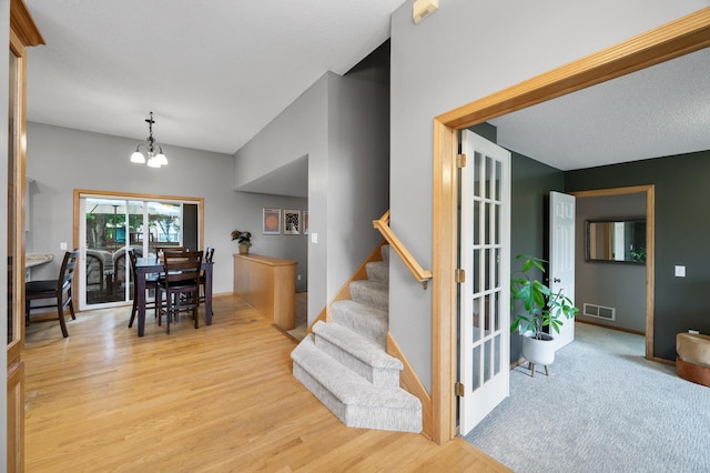 4032 Hollyhock Cir N, Brooklyn Park, MN 55443 - entryway featuring light wood-style flooring, stairway, and a chandelier