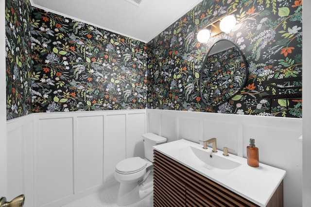 4032 Hollyhock Cir N, Brooklyn Park, MN 55443 - bathroom with wallpapered walls, a decorative wall, vanity, ornamental molding, and a wainscoted wall