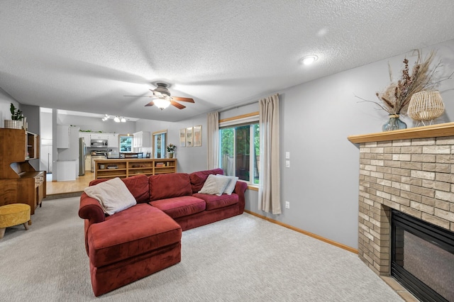 4032 Hollyhock Cir N, Brooklyn Park, MN 55443 - carpeted living area featuring a fireplace, a ceiling fan, and a textured ceiling