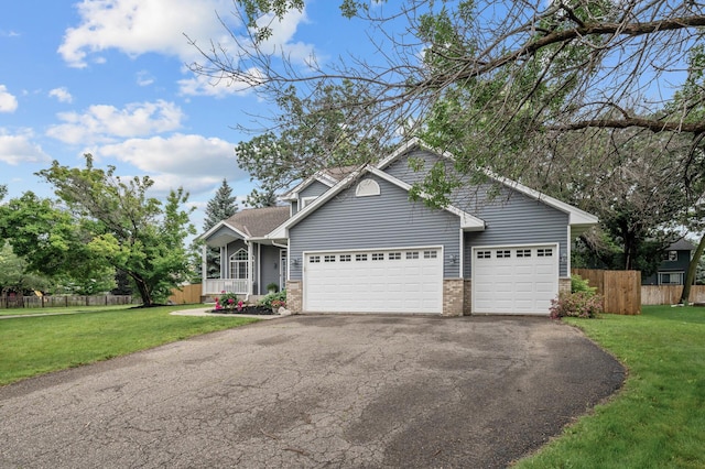 4032 Hollyhock Cir N, Brooklyn Park, MN 55443 - view of front of property with asphalt driveway, brick siding, and a garage