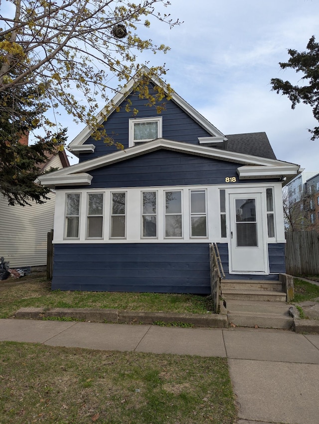 bungalow-style house featuring fence and entry steps