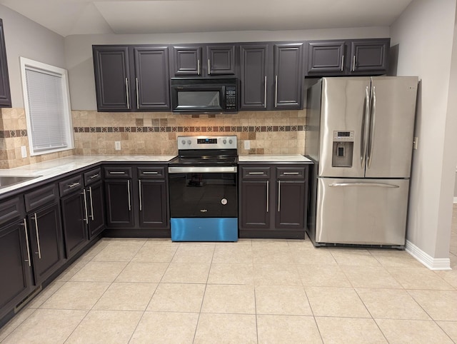 kitchen featuring light countertops, appliances with stainless steel finishes, backsplash, and light tile patterned floors