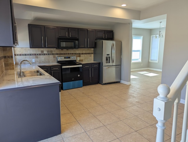 kitchen featuring decorative backsplash, recessed lighting, a sink, light tile patterned floors, and stainless steel appliances