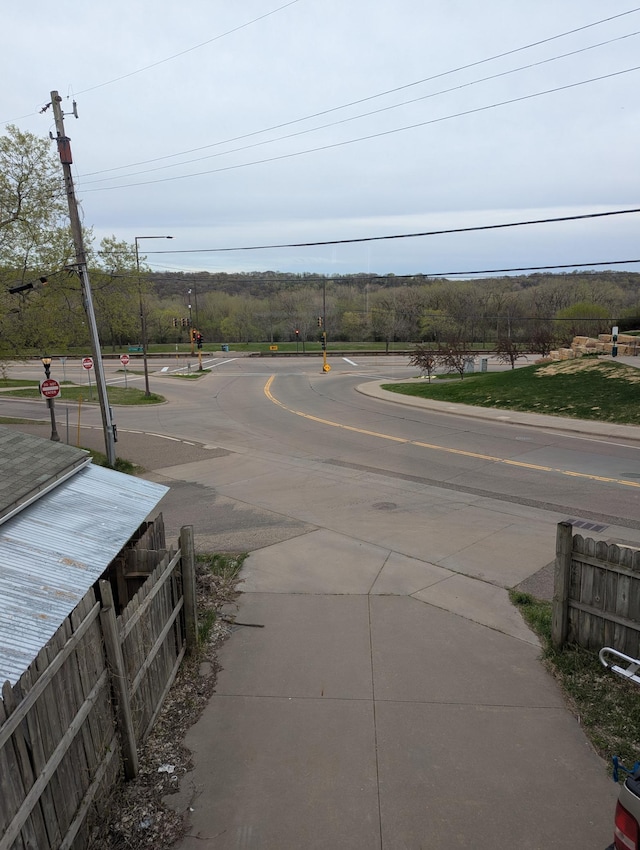 view of street with street lights, traffic signs, and sidewalks