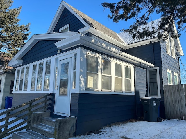 view of front of property featuring entry steps and fence