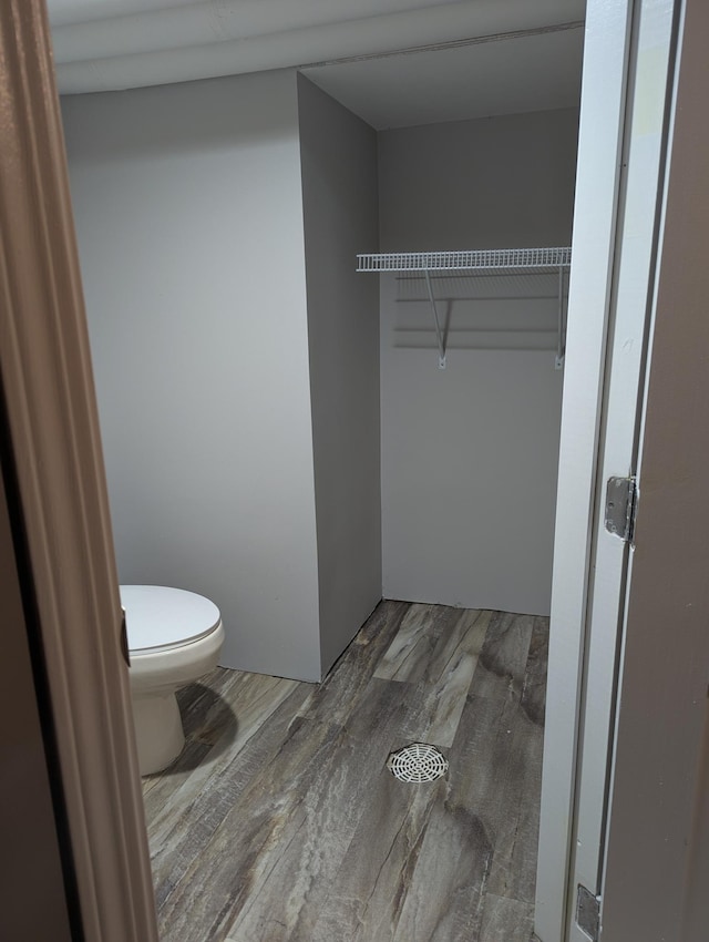 bathroom with toilet and wood finished floors