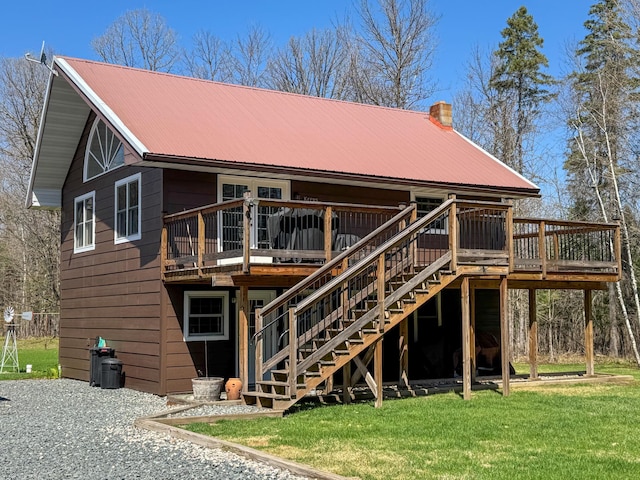 17783 Lookout Tower Rd NE, Hines, MN 56647 - rear view of house featuring a deck, metal roof, a lawn, and a chimney
