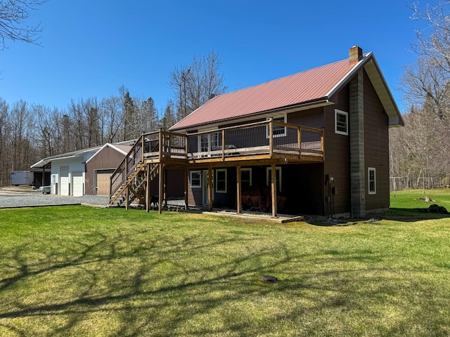 17783 Lookout Tower Rd NE, Hines, MN 56647 - back of property featuring a chimney, a deck, stairs, a lawn, and metal roof